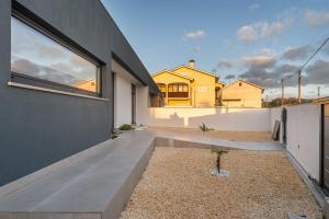 a view of the backyard of a house at Dune House - Villa With Private Dune and Sea View in Viana do Castelo
