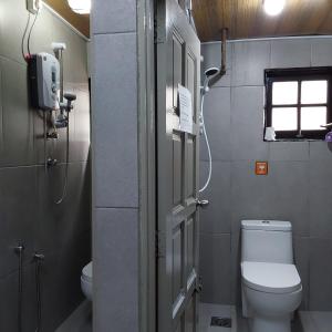a small bathroom with a toilet and a window at BRICKS Backpackers Sleepbox in Tanah Rata +35 photos