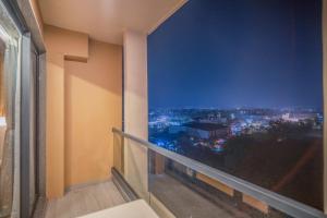 a balcony with a view of a city at night at The Vilton in Raipur
