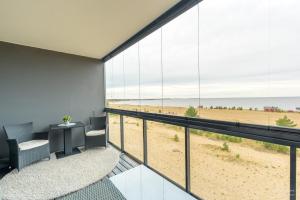 an office with a view of the beach from the balcony at Timantti Apartments by Hiekka Booking in Kalajoki