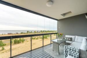 a living room with a view of the beach at Timantti Apartments by Hiekka Booking in Kalajoki +71 photos