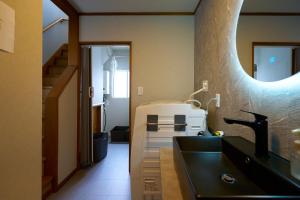 a bathroom with a black sink and a mirror at Imari in Asahikawa +63 photos