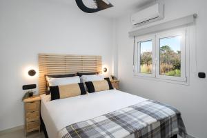 a white bedroom with a bed and a window at Alea Villa in Ierapetra +10 photos