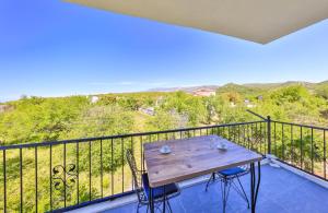 a wooden table on a balcony with a view at Villa Nazard in Kaş