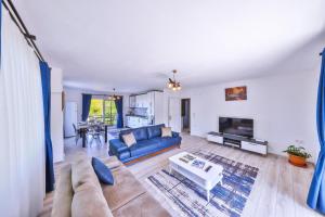 a living room with a blue couch and a table at Villa Nazard in Kaş