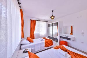a hotel room with two beds and a mirror at Villa Nazard in Kaş +18 photos