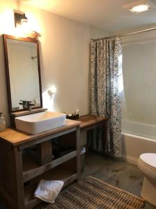 a bathroom with a sink and a mirror at Shackmatack in Tenants Harbor +26 photos
