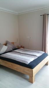 a bedroom with a wooden bed in a room at Doppelzimmer mit direktem Moselblick in Briedern