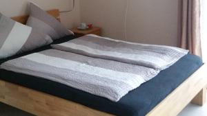 a bedroom with a bed with two blankets on it at Doppelzimmer mit direktem Moselblick in Briedern