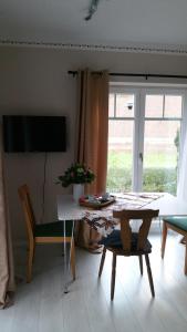 a living room with a table and a chair and a television at Doppelzimmer mit direktem Moselblick in Briedern