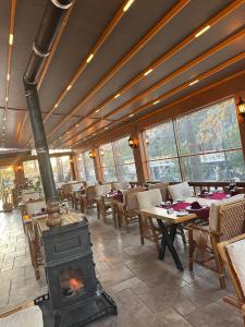 a fireplace in a restaurant with tables and chairs at Caria Special Class in Dalyan