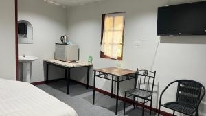 a room with a bed and two chairs and a tv at Similan Resort & Water Fall in Ban Lam Ru (1)