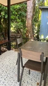 a wooden table and a chair on a patio at Similan Resort & Water Fall in Ban Lam Ru (1)