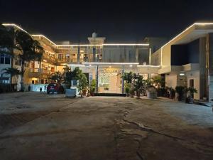 an empty parking lot in front of a building at night at Satkar palace hotel in Naugarh
