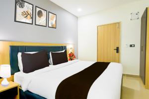 a bedroom with a large bed in a room at Townhouse Aarav Business Hotel in Hyderabad
