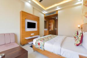 a hotel room with a bed and a tv at INDRA PALACE Unit 2 in Jaipur