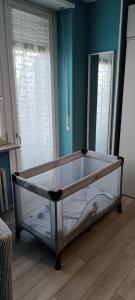 a bed frame in a room with blue walls at L'Alloggetto sul Corso in Cuneo
