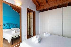 a bedroom with two beds and a mirror at Hostdomus - Villa Bea free garage and pool in Magliolo