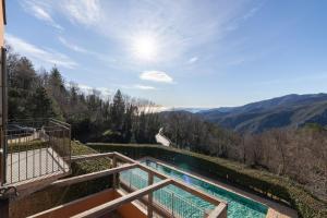 a view from the balcony of a house with a swimming pool at Hostdomus - Villa Bea free garage and pool in Magliolo