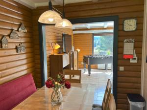 a dining room with a table and a piano at Haus 44 Feldblick in Arrach