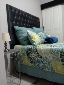 a bedroom with a bed with pillows and a table at SummerPlace Guest Rooms in Modimolle