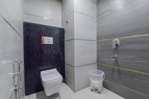 a bathroom with a white toilet and a sink at INDRA PALACE Unit 2 in Jaipur +35 photos
