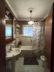 a bathroom with a sink and a tub and a shower at Torricella Hosting in Torricella +75 photos