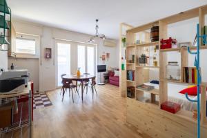 a living room with a table and a dining room at Bindarella ai Navigli in Milan