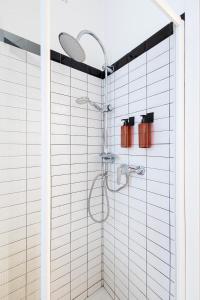 a bathroom with a shower with white tiles at Bindarella ai Navigli in Milan
