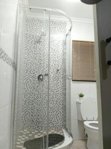 a shower with a glass door in a bathroom at SummerPlace Guest Rooms in Modimolle +16 photos