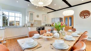 a kitchen and dining room with a table and chairs at Blackway House in Canon Frome