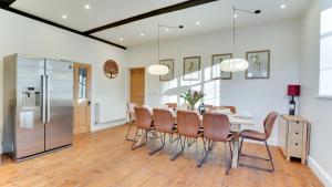 a kitchen and dining room with a table and chairs at Blackway House in Canon Frome