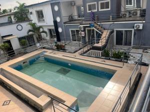 a swimming pool in the middle of a house at Mobile Unique Apt in Ikeja
