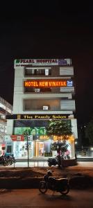 a building with a motorcycle parked in front of it at Hotel New Vinayak in Ahmedabad