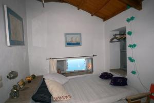 a bedroom with a bed in a room with a window at Heavens Nest in Mythimna