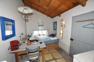 a bedroom with a bed and a desk in a room at Heavens Nest in Mythimna