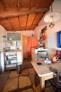 a kitchen with wooden ceilings and a table in a room at Heavens Nest in Mythimna