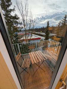 a balcony with two wooden benches on a deck at Montelio Living in Ettlingen