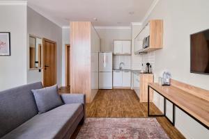 a living room with a couch and a kitchen at Aisha Bibi Hotel & Spa in Astana +34 photos