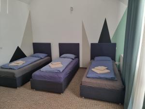 three beds in a room with purple beds at Munich Residence in Cristian +71 photos