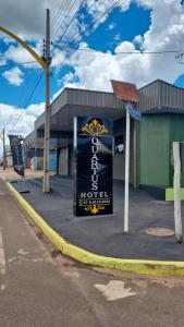 a sign for a hotel on the side of a street at Quartus Hotel in Água Boa