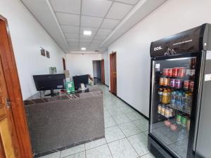 a room with a refrigerator filled with drinks at Quartus Hotel in Água Boa