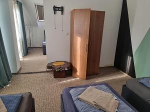 a room with a bed and a wooden cabinet at Munich Residence in Cristian