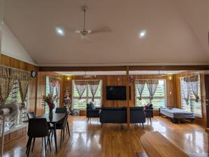 a living room with a table and chairs at Naghoniara Airport Transit in Honiara