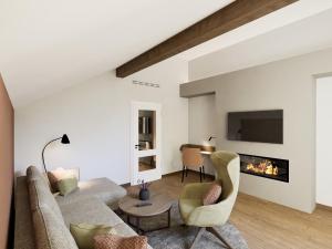 a living room with a couch and a fireplace at Churfürstenhof Wellnesshotel in Bad Birnbach