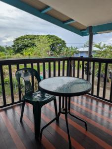 a table and a chair on a deck at Naghoniara Airport Transit in Honiara