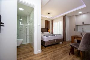 a bedroom with a bed and a bathroom with a shower at Apartment Sofija in Budva +154 photos