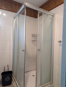 a shower with a glass door in a bathroom at Naghoniara Airport Transit in Honiara +7 photos