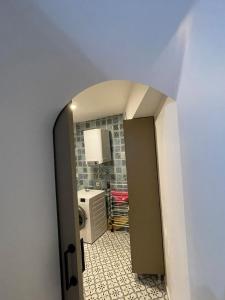 a hallway leading to a laundry room with a washer and dryer at Kıymet Aydogdu in Alaçatı +2 photos