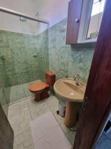 a bathroom with a sink and a shower and a toilet at Quartus Hotel in Água Boa +28 photos